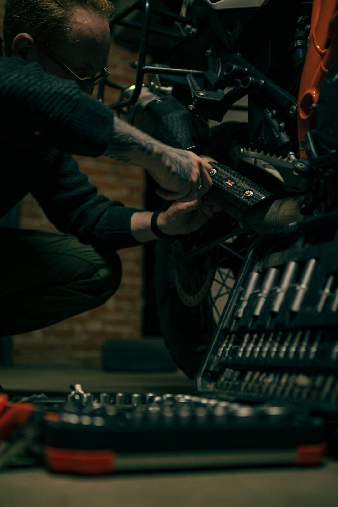 Mechanic inspecting a premium car engine in a clean modern workshop
