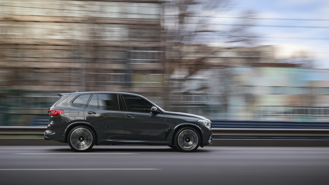 Dark blue BMW X5 SUV parked in a modern urban plaza in Montevideo