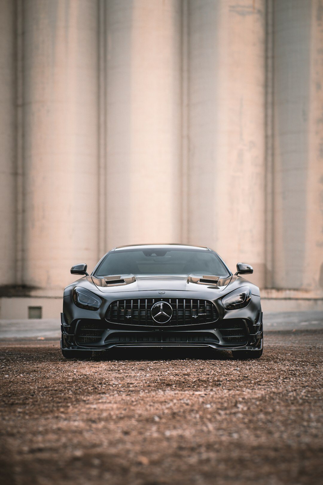 Black Mercedes-Benz S-Class executive sedan in a dramatic underground garage