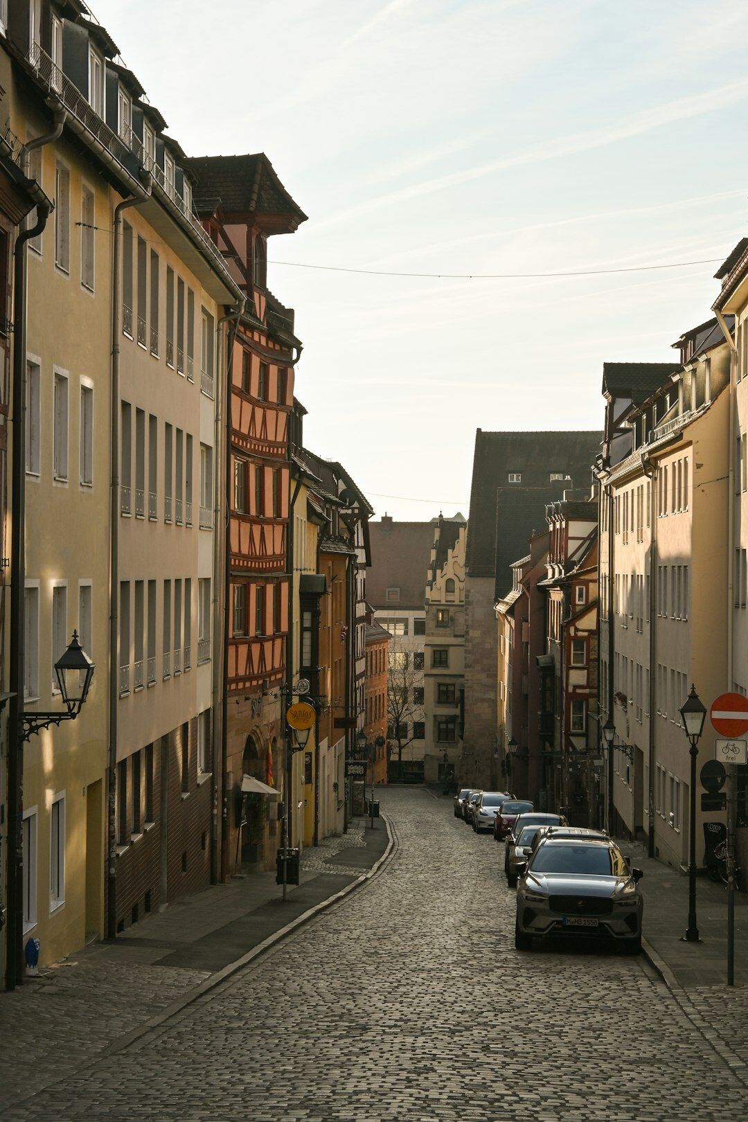 German luxury sedan parked on a European cobblestone street