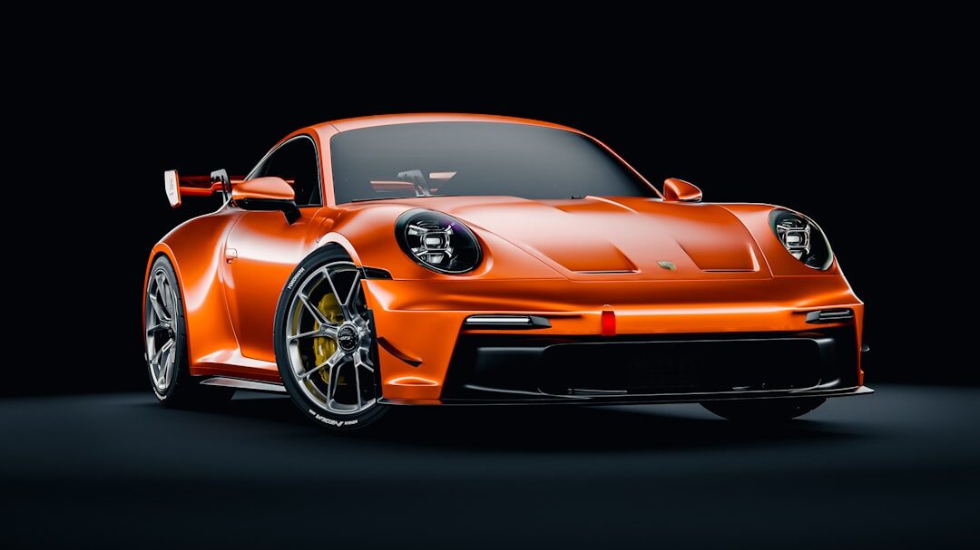 Black Porsche 911 sports car under dramatic studio lighting