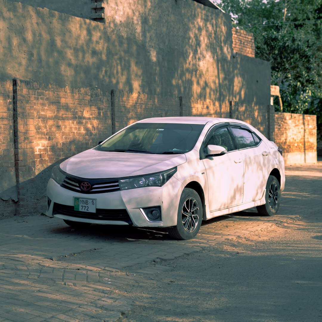 Silver Toyota Corolla Hybrid sedan on an urban street